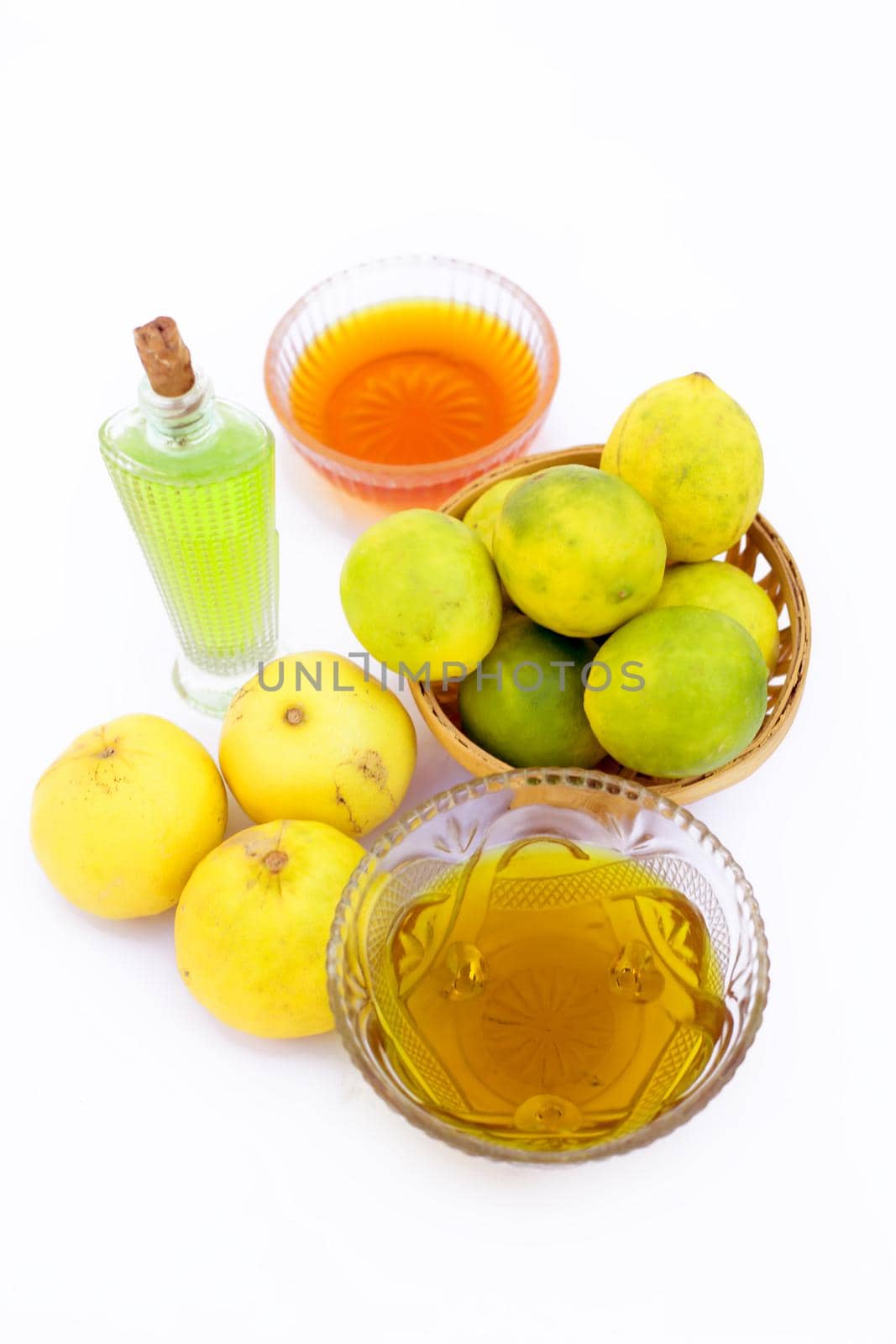 Lemon hair growth mask isolated on white i.e. Lemon juice well mixed with honey and Olive oil in a glass bowl with entire raw ingredients. by mirzamlk