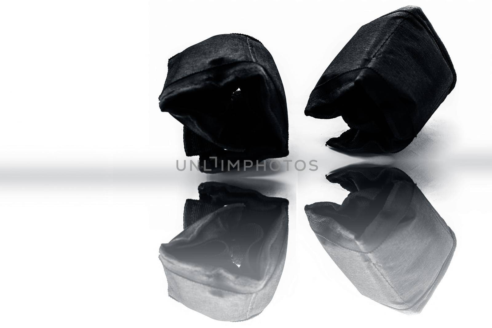 Black colored ankle weights isolated on white.