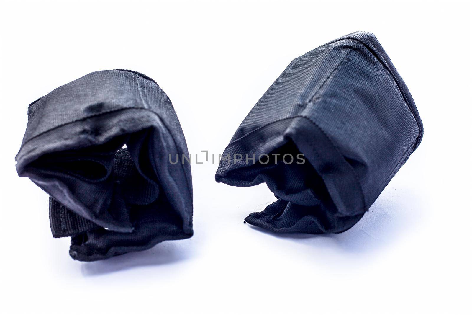 Black colored ankle weights isolated on white.