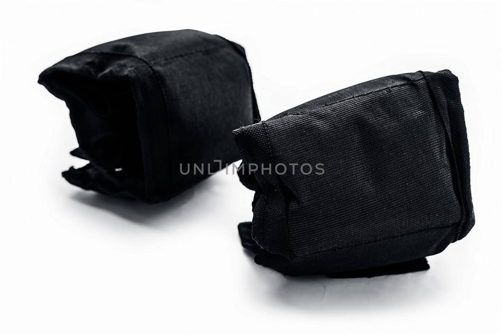 Black colored ankle weights isolated on white.