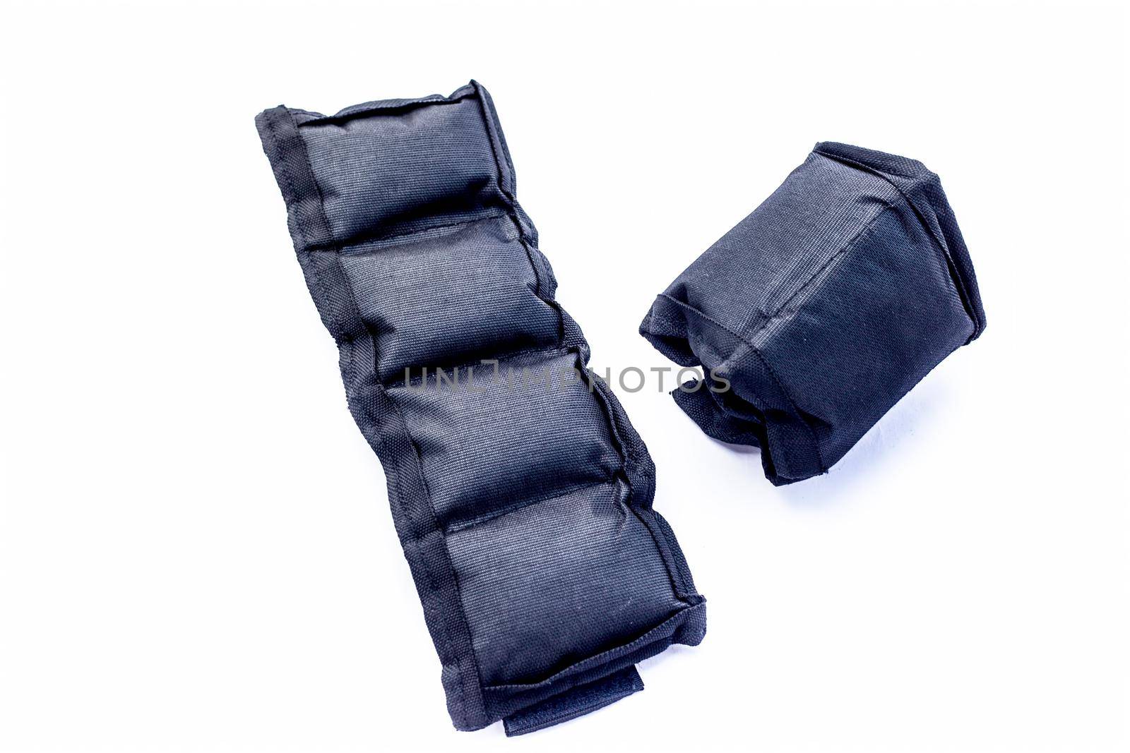 Black colored ankle weights isolated on white.