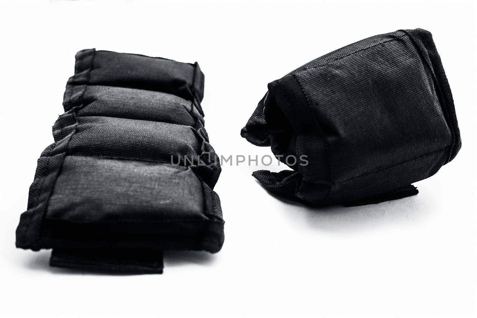 Black colored ankle weights isolated on white.