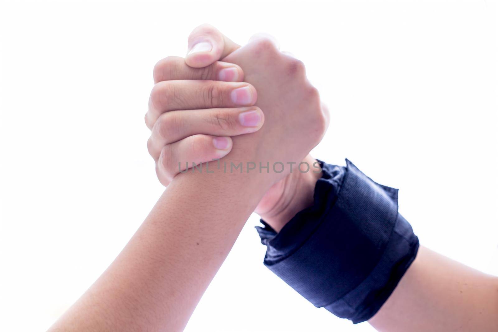 Male hand wearing black colored wrist weights and helping the other female hand isolated on white.Concept of togetherness and teamwork. by mirzamlk