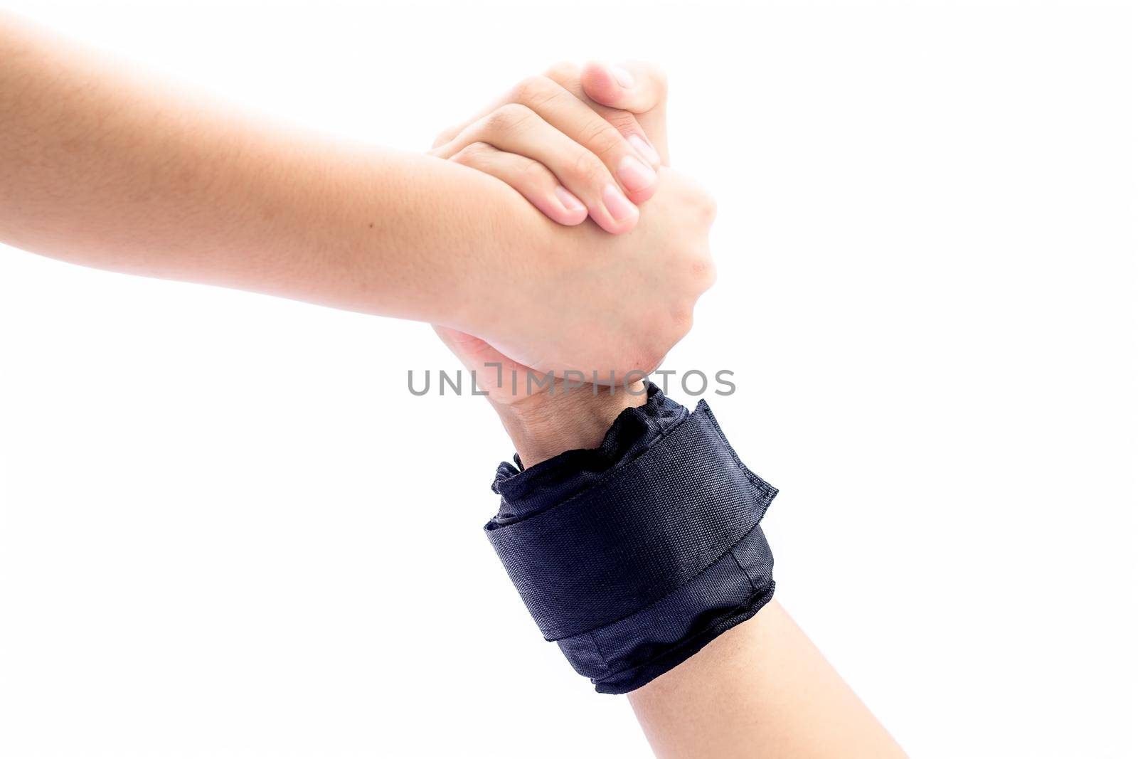 Male hand wearing black colored wrist weights and helping the other female hand isolated on white.Concept of togetherness and teamwork. by mirzamlk