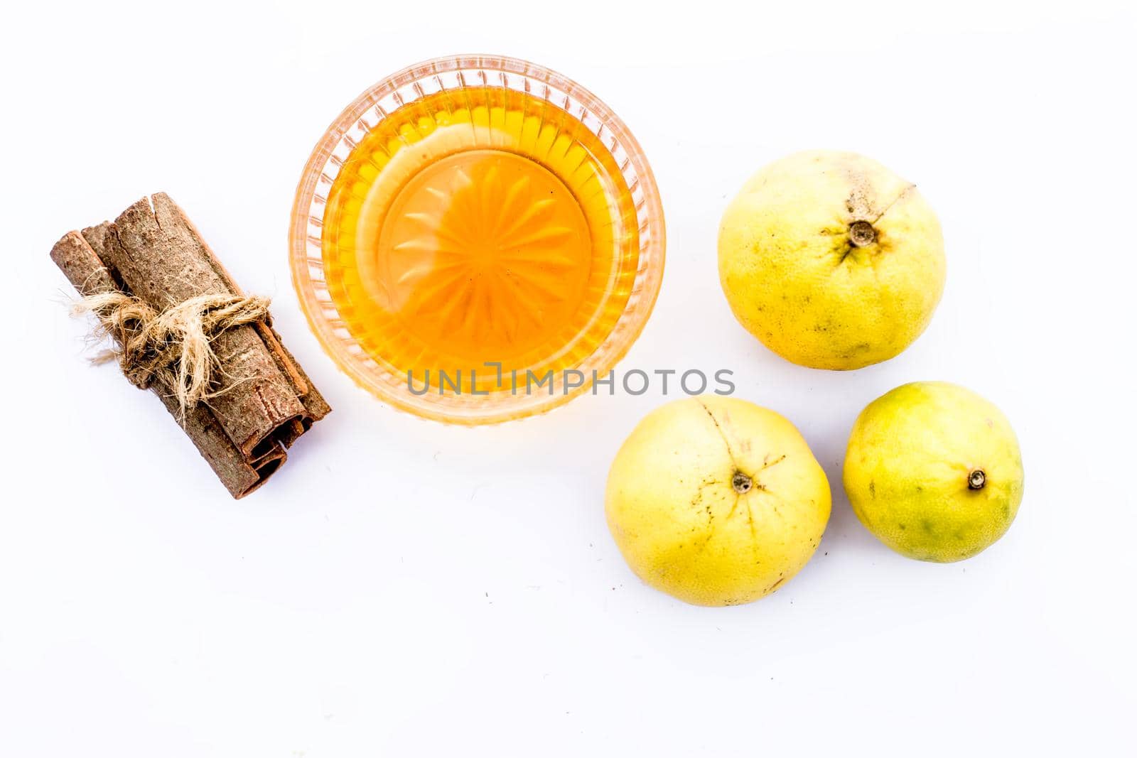 Cinnamon face pack isolated on white i.e. Cinnamon powder well mixed with lemon and honey and removes dark spots, eliminates scars, and moisturizes your skin.Entire raw ingredients present.