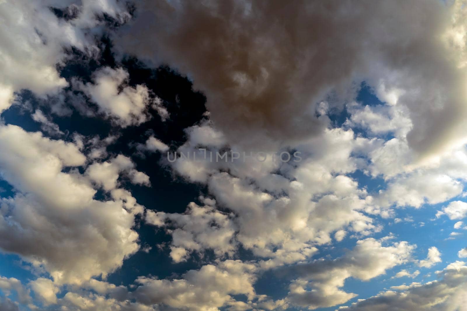 Panoramic view of the blue sky with clouds in motion. View of the blue sky with clouds in motion.Nice weather with clear skies.Heavenly Light.Dramatic sky with clouds by YevgeniySam