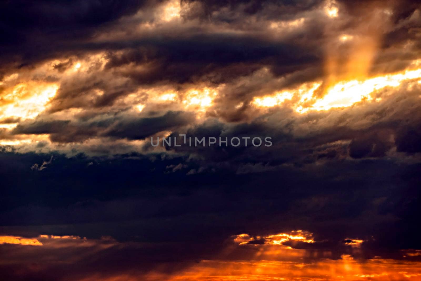 The heavenly light of the sun.Dramatic evening sky with clouds and rays of the sun.Sunlight at evening sunset or morning dawn.Panoramic view of the blue sky with clouds in motion.Sunset and sunlight by YevgeniySam