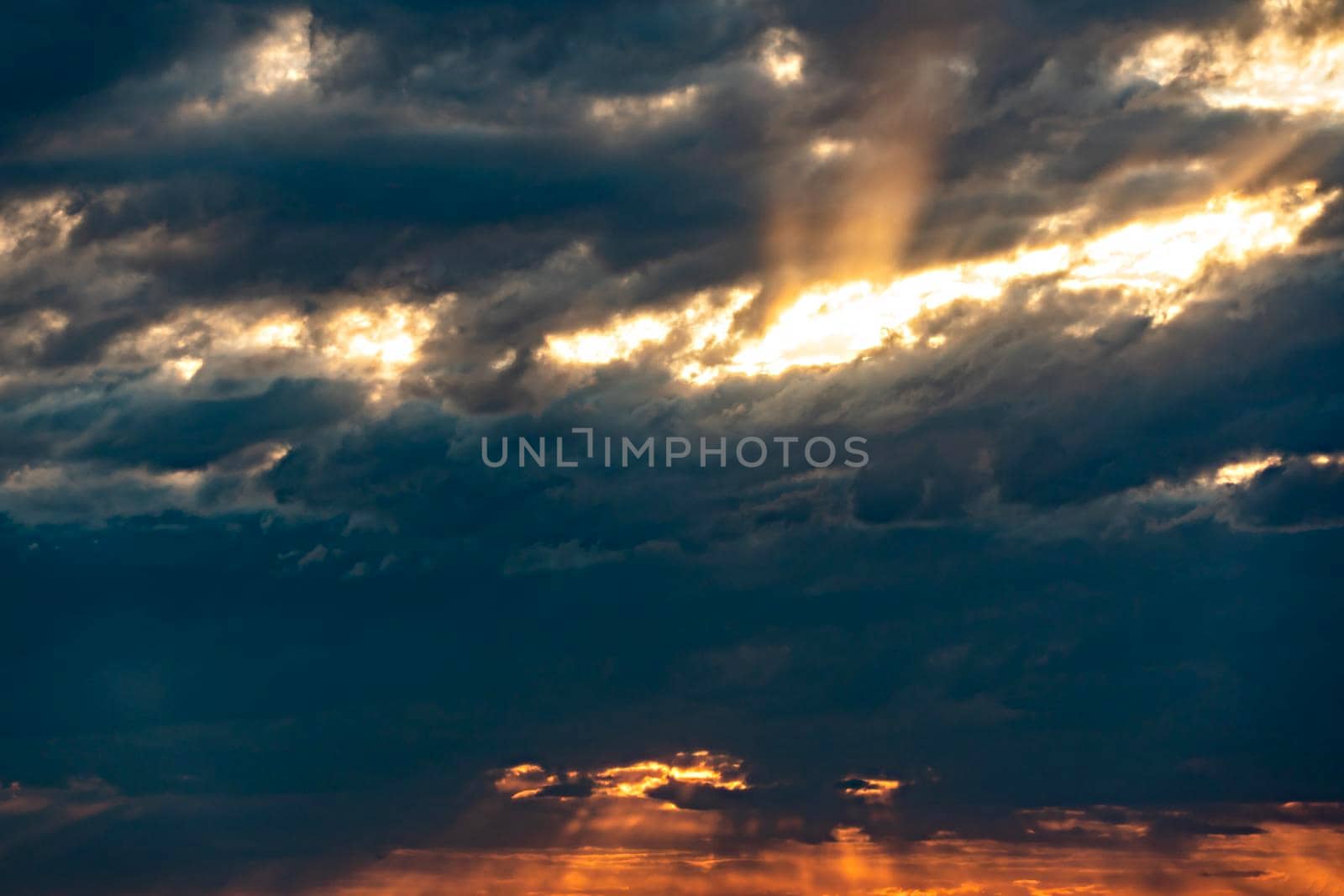 The heavenly light of the sun.Dramatic evening sky with clouds and rays of the sun.Sunlight at evening sunset or morning dawn.Panoramic view of the blue sky with clouds in motion.Sunset and sunlight by YevgeniySam