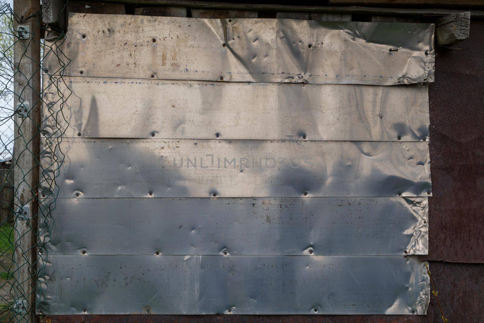 horizontal shiny stainless steel sheets nailed to flat surface - flat background and texture
