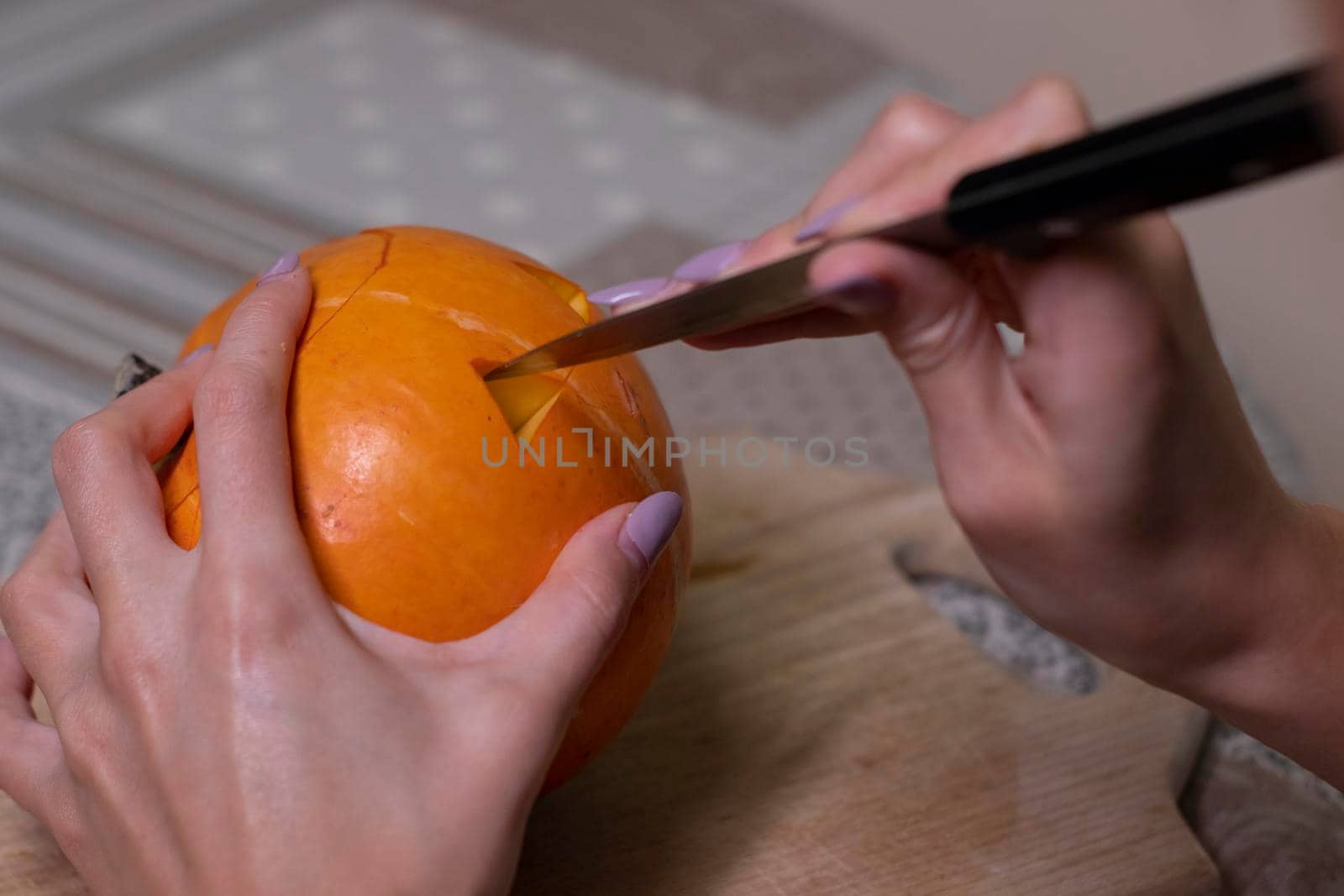 the process of making a Halloween pumpkin. cutting out eyes. horror theme and Hallowe'en by oliavesna