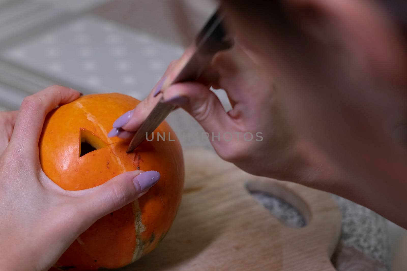 the process of making a Halloween pumpkin. cutting nose. horror theme and Hallowe'en.