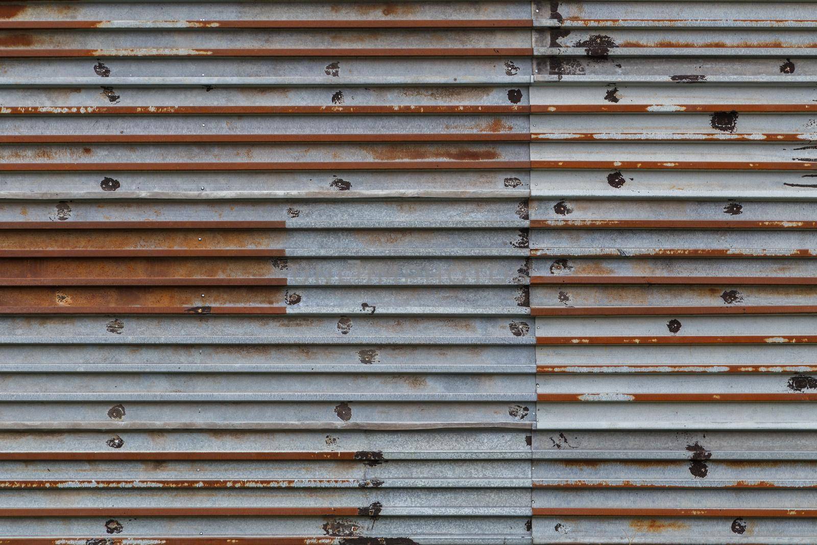 rusted corrugated steel sheets with leftovers of zync plating background and texture.