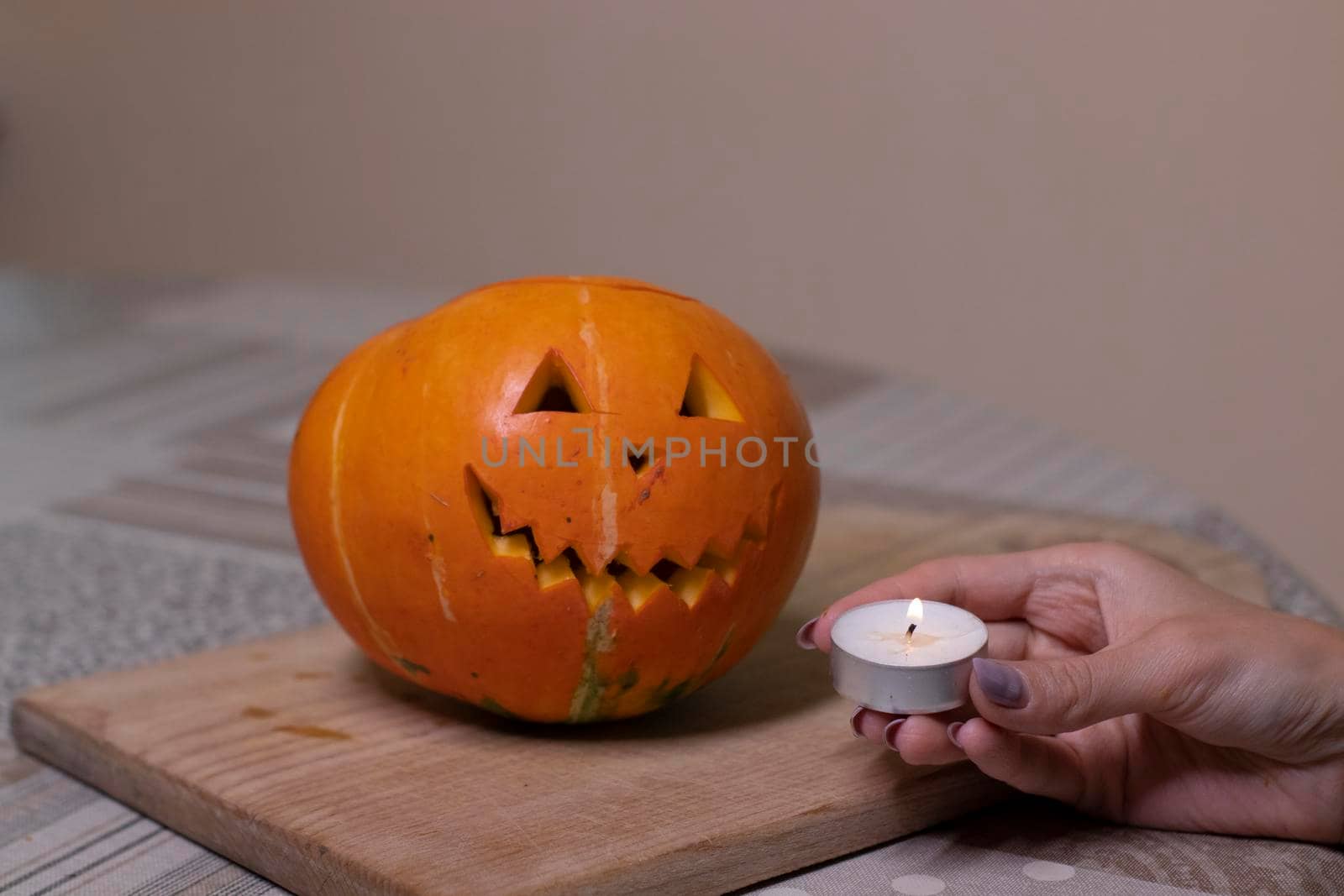 the process of making a Halloween pumpkin. lighted candle. horror theme and Hallowe'en by oliavesna