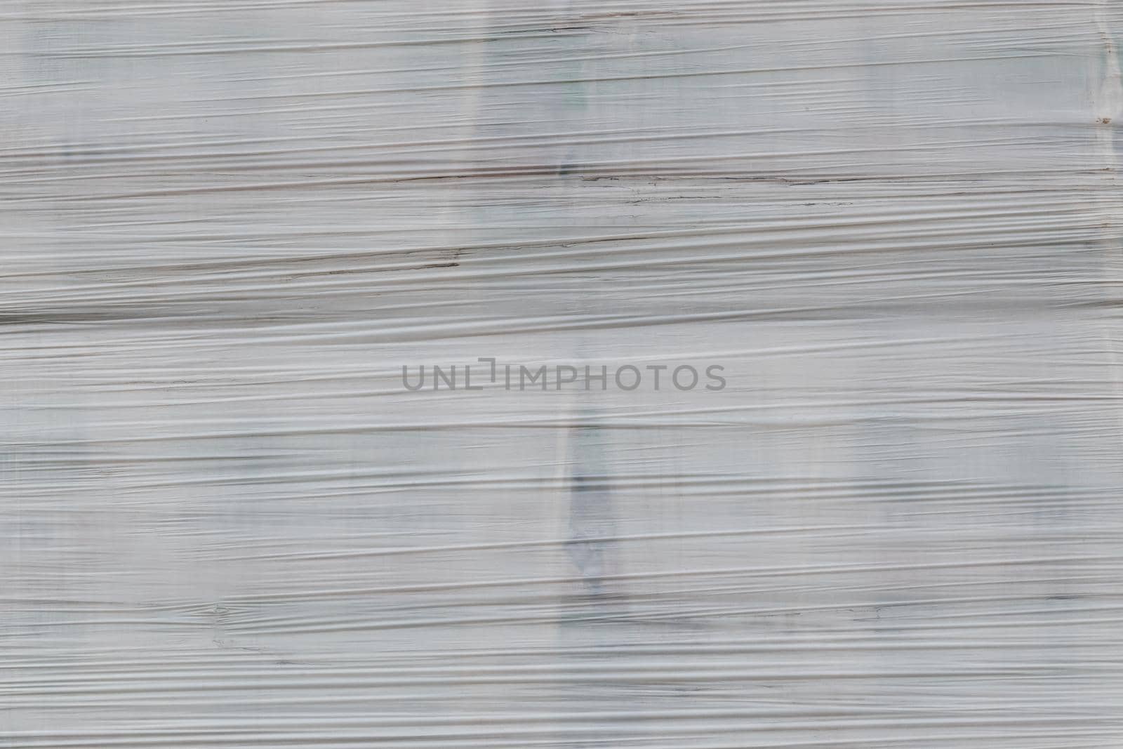 white shrink wrap film with horizontal folds - full frame background and flat texture.