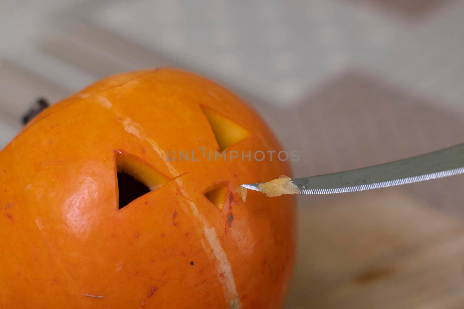 the process of making a Halloween pumpkin. cutting nose. horror theme and Hallowe'en.