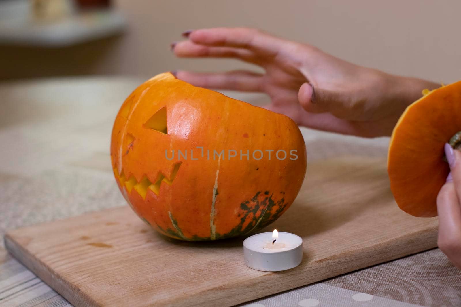 the process of making a Halloween pumpkin. lighted candle. horror theme and Hallowe'en.