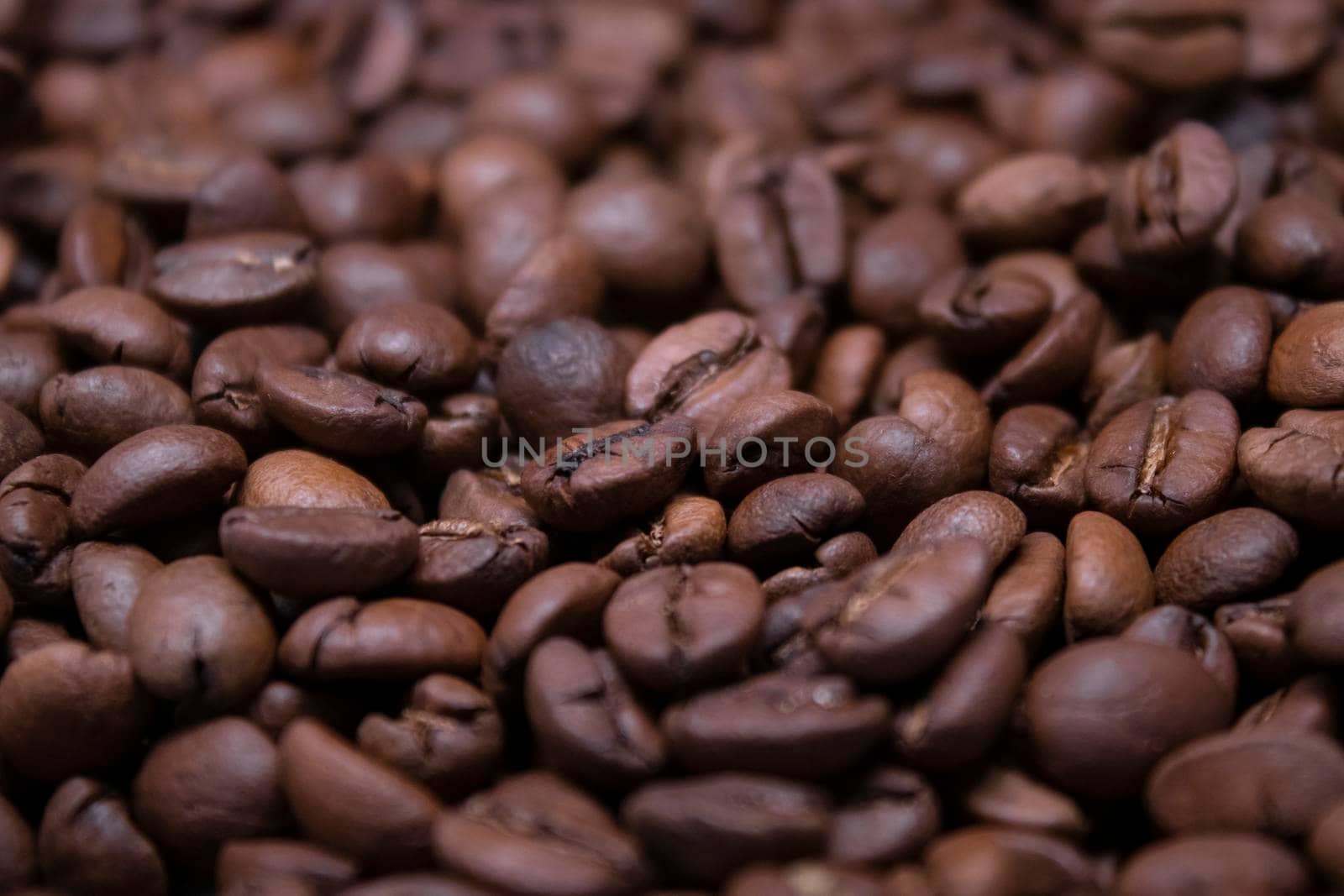 close up of Freshly roasted coffee beans background. top view by oliavesna