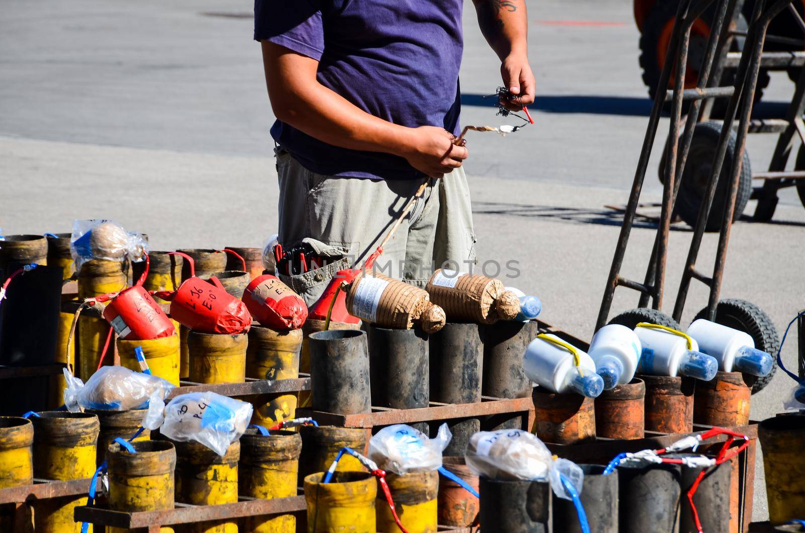 Worker connecting wires to set up fire works display.