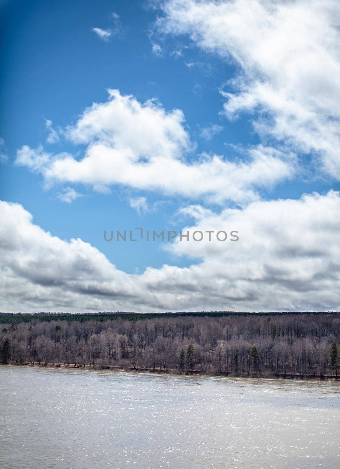 A beautiful, wide river in the spring among the forests. Quiet and peaceful place. Not clear, muddy water in the river. Top view of the distance