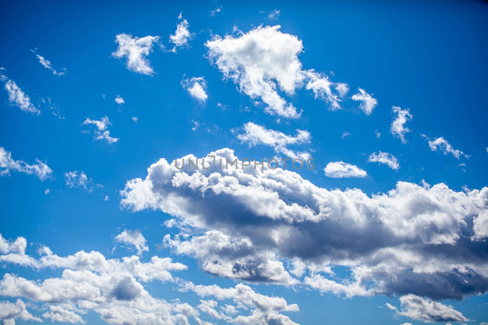 Big white clouds in a blue sky close-up. There is a place for the text. The concept of cleanliness in nature and caring for nature