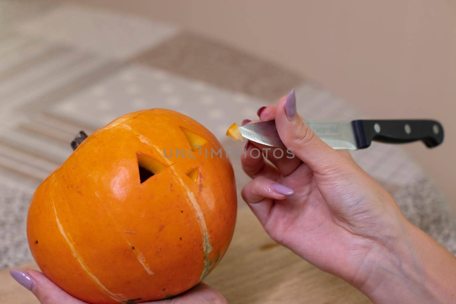 the process of making a Halloween pumpkin. cutting nose. horror theme and Hallowe'en.