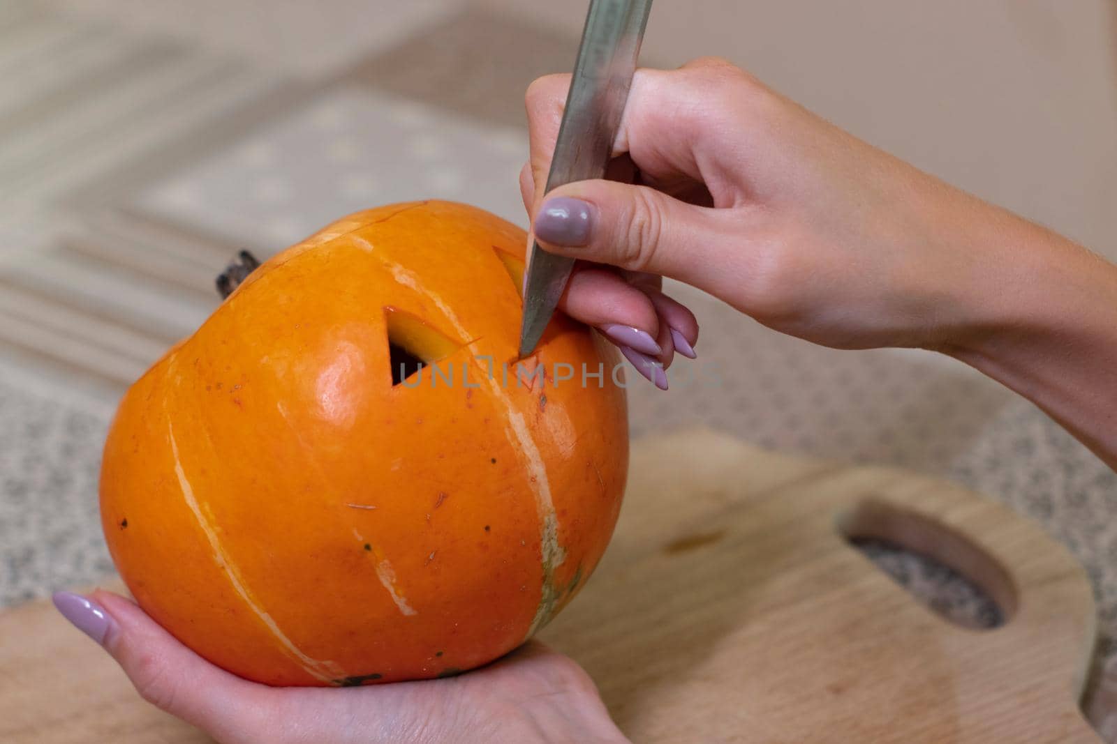 the process of making a Halloween pumpkin. cutting nose. horror theme and Hallowe'en.