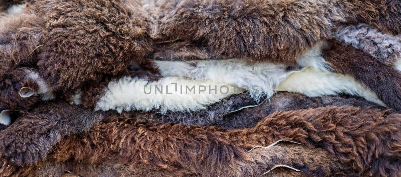 Layers of animal pelts in various shades from white to brown