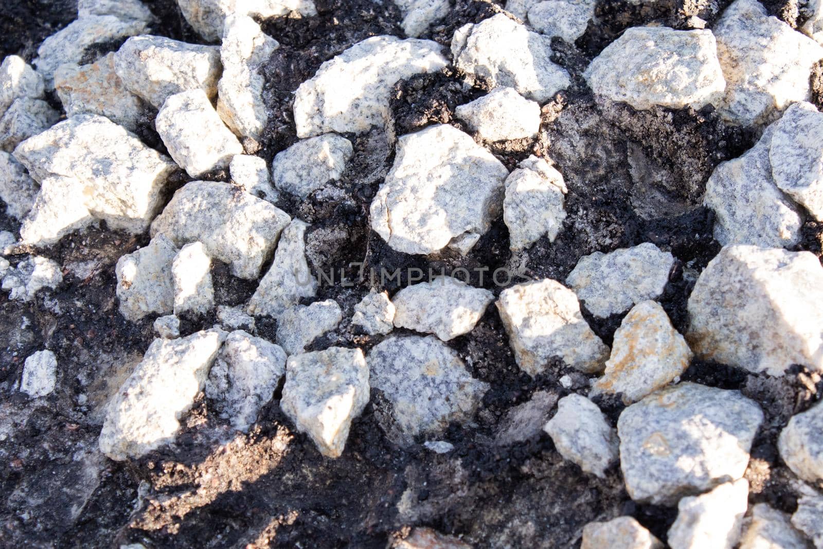 close-up of Old cracked asphalt pavement. concept of reduce reuse recycle. pile of smashed concrete. Destroyed highway, damage and collapse. Disaster results, earthquake or accident.