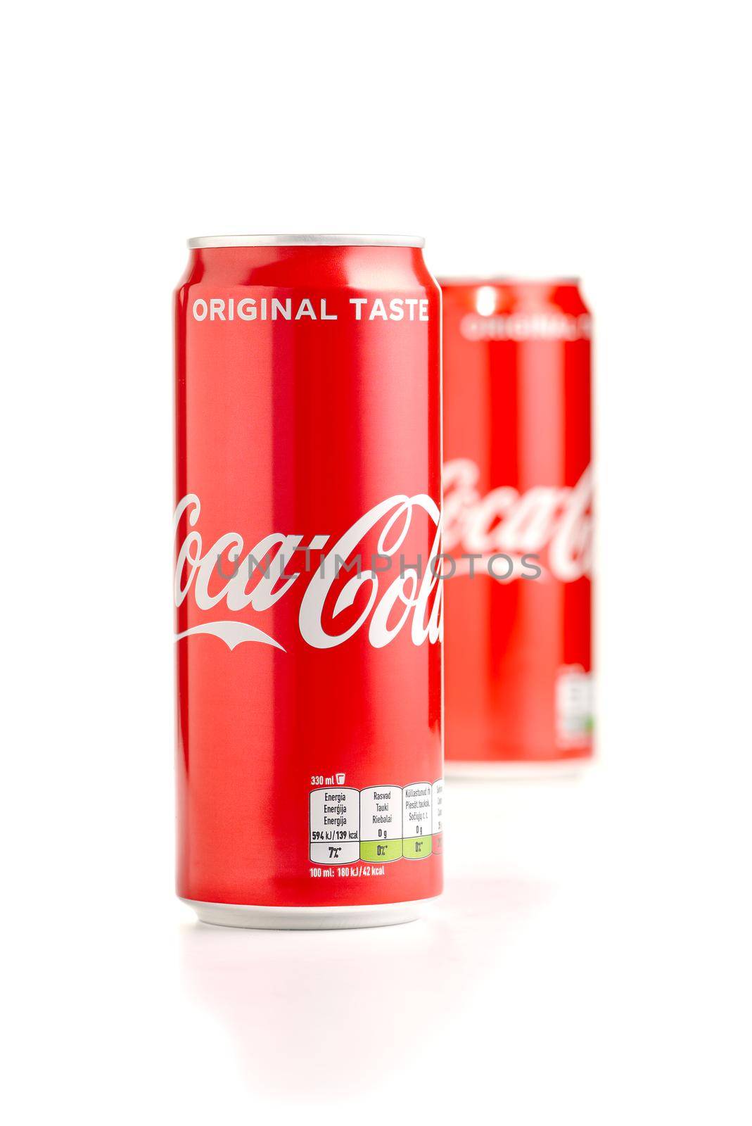 Tallinn, Estonia - 10.05.2021: Closeup of two aluminum red can of Coca-Cola. Coca-Cola popular soda drink isolated on white