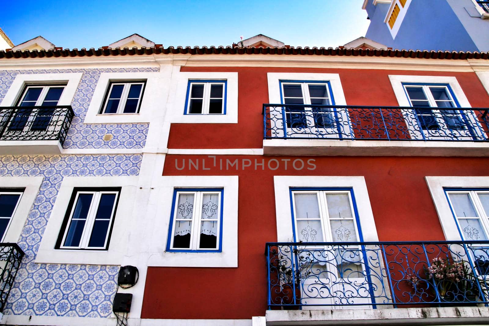 Old colorful houses and streets of Lisbon, Portugal in Spring. Majestic facades and old street lights.