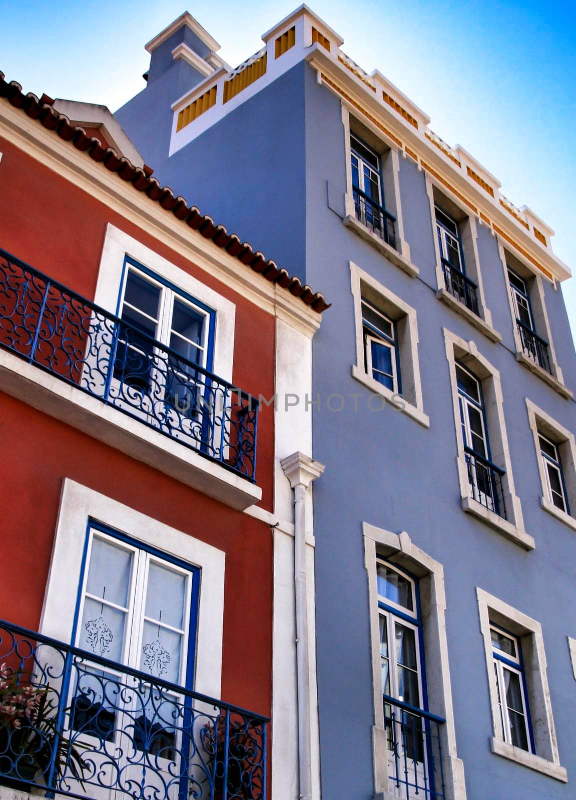 Old colorful houses and streets of Lisbon, Portugal in Spring. Majestic facades and old street lights.