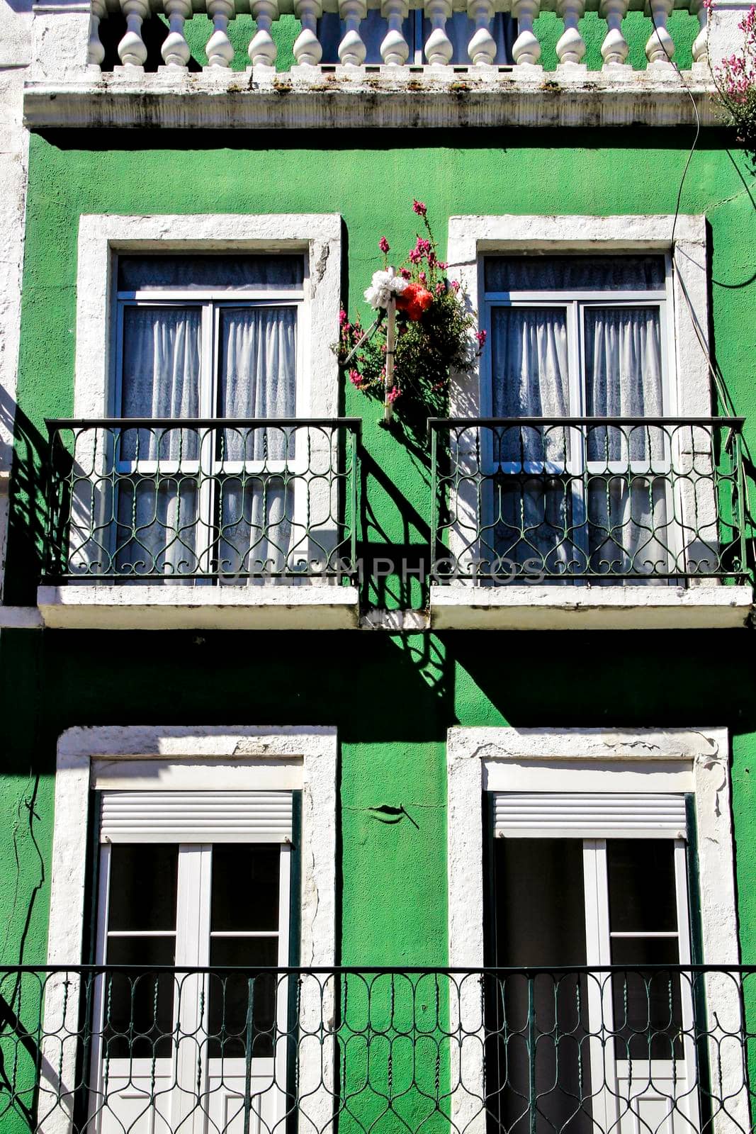Old colorful houses and streets of Lisbon, Portugal in Spring. Majestic facades and old street lights.