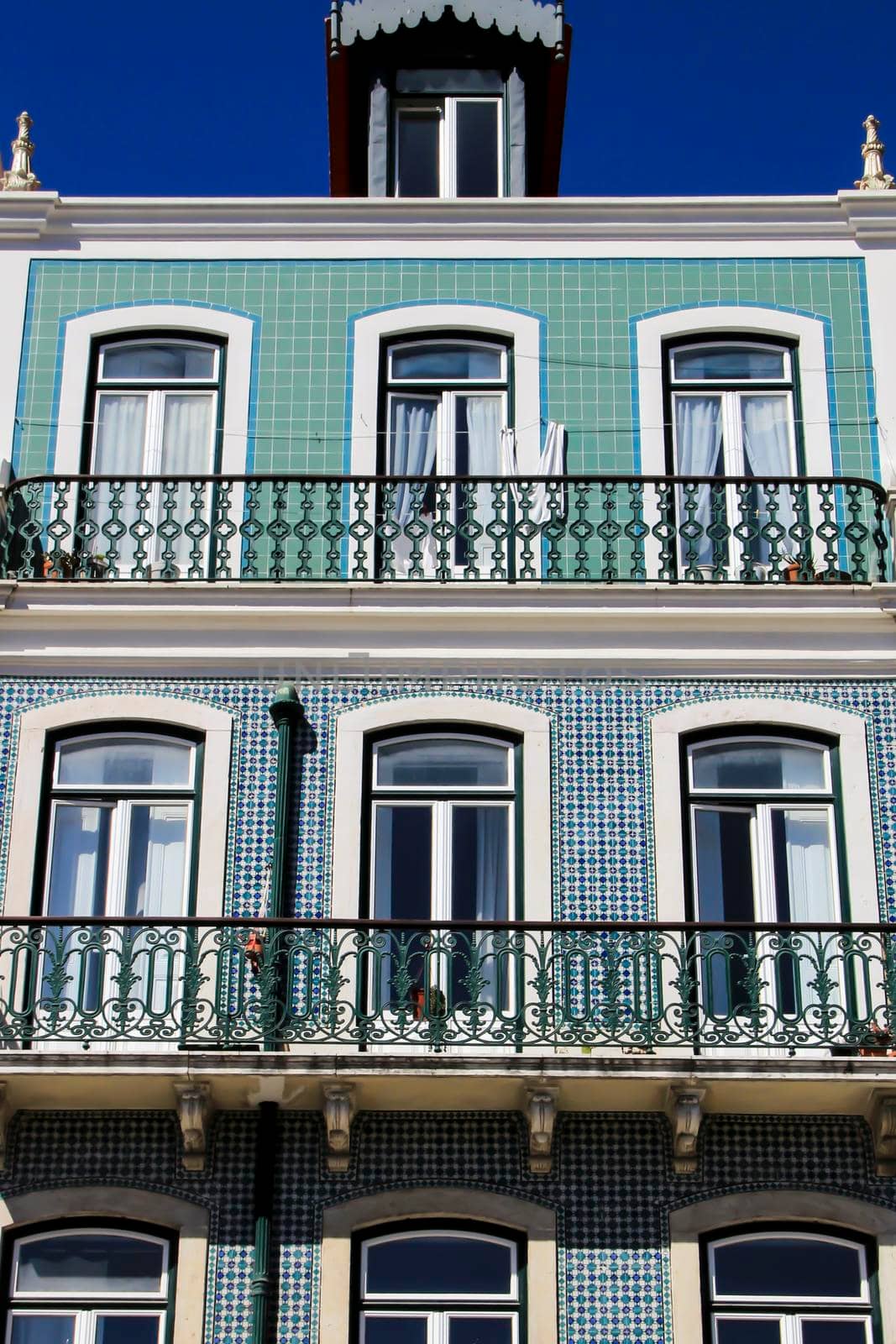 Old colorful houses and streets of Lisbon, Portugal in Spring. Majestic facades and old street lights.