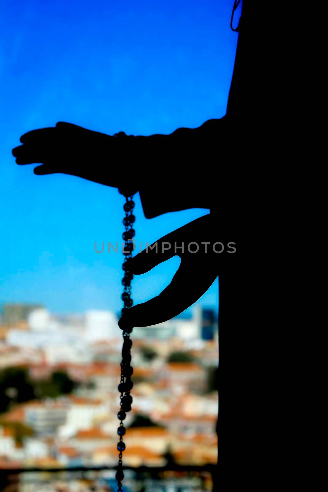Image of the Virgin Mary hands holding a rosary in Nossa Senhora Do Monte viewpoint in Lisbon in a sunny day of winter