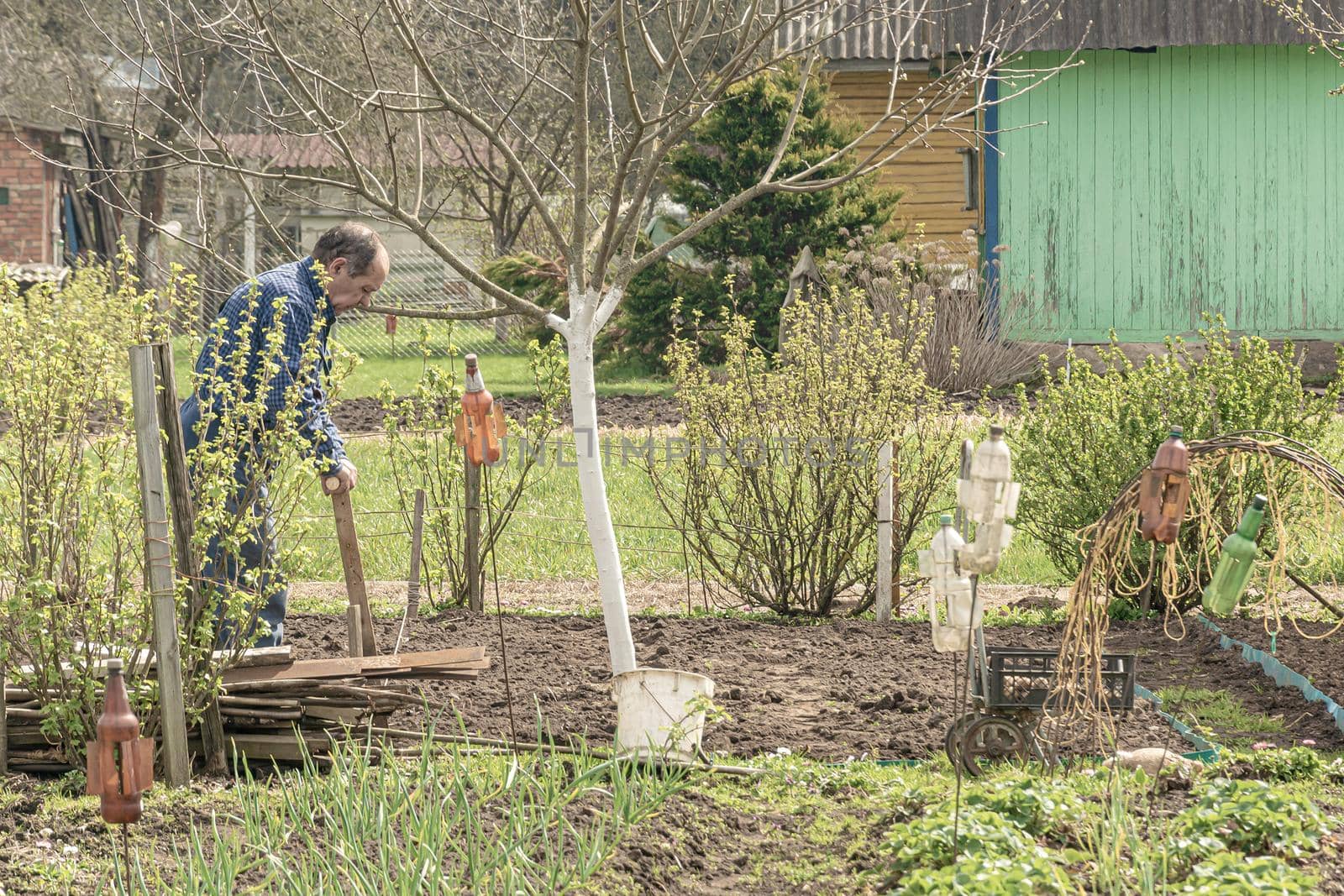 POLAND, Lomza - May 01, 2021: A farmer on a private farmstead is engaged in agricultural work. Stock photo.
