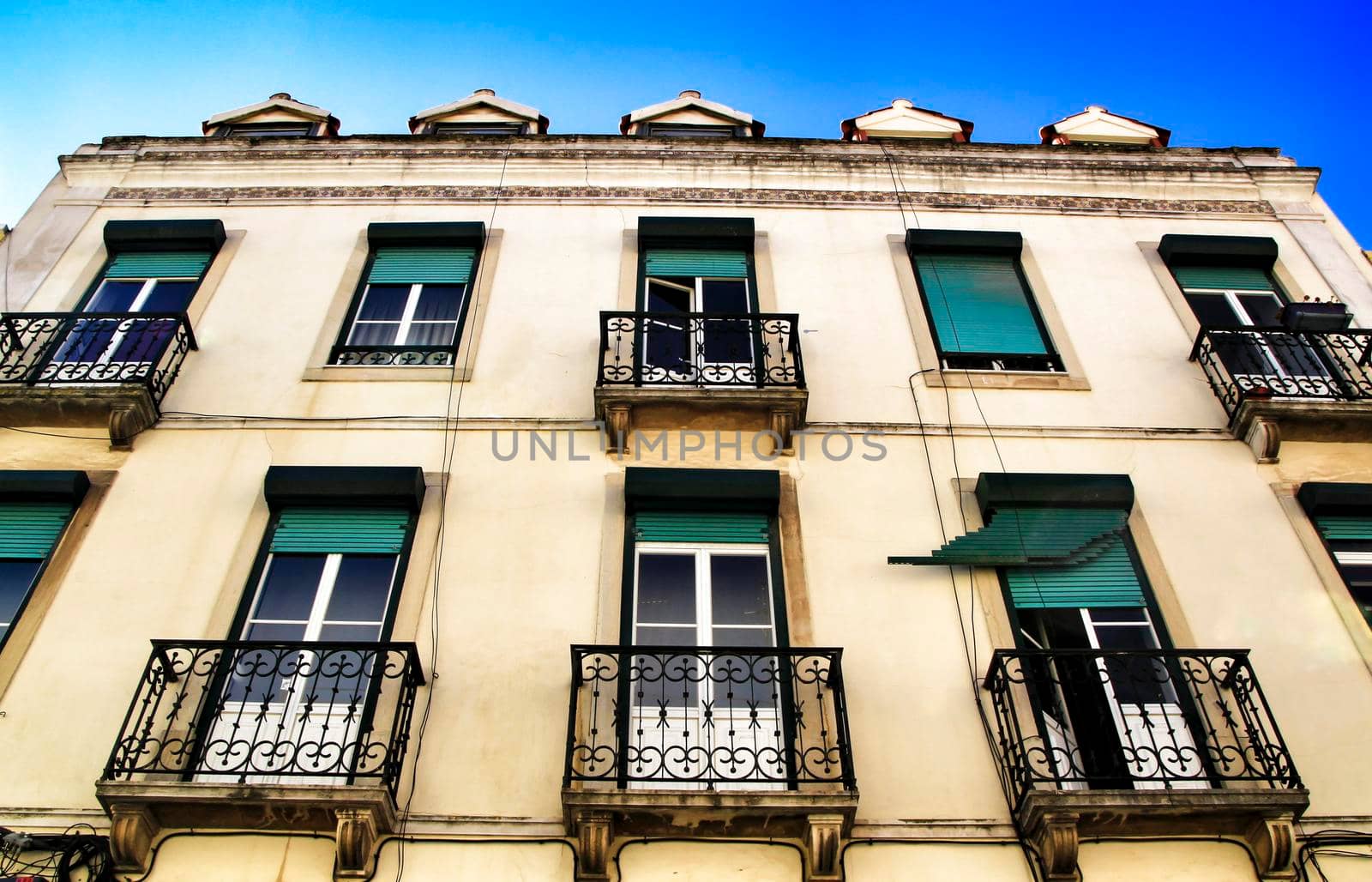 Old colorful houses and streets of Lisbon, Portugal in Spring. Majestic facades and old street lights.