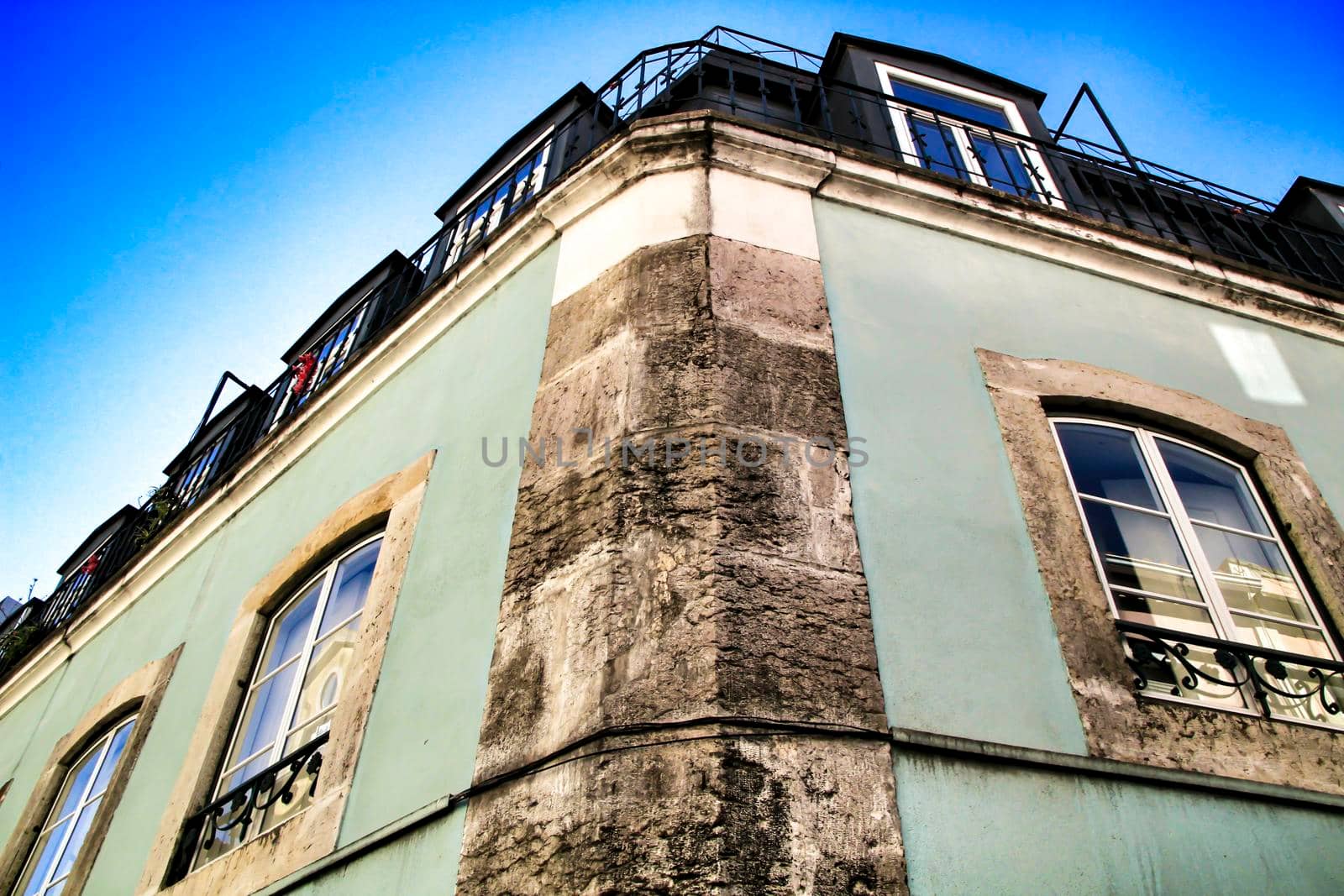 Old colorful houses and streets of Lisbon, Portugal in Spring. Majestic facades and old street lights.