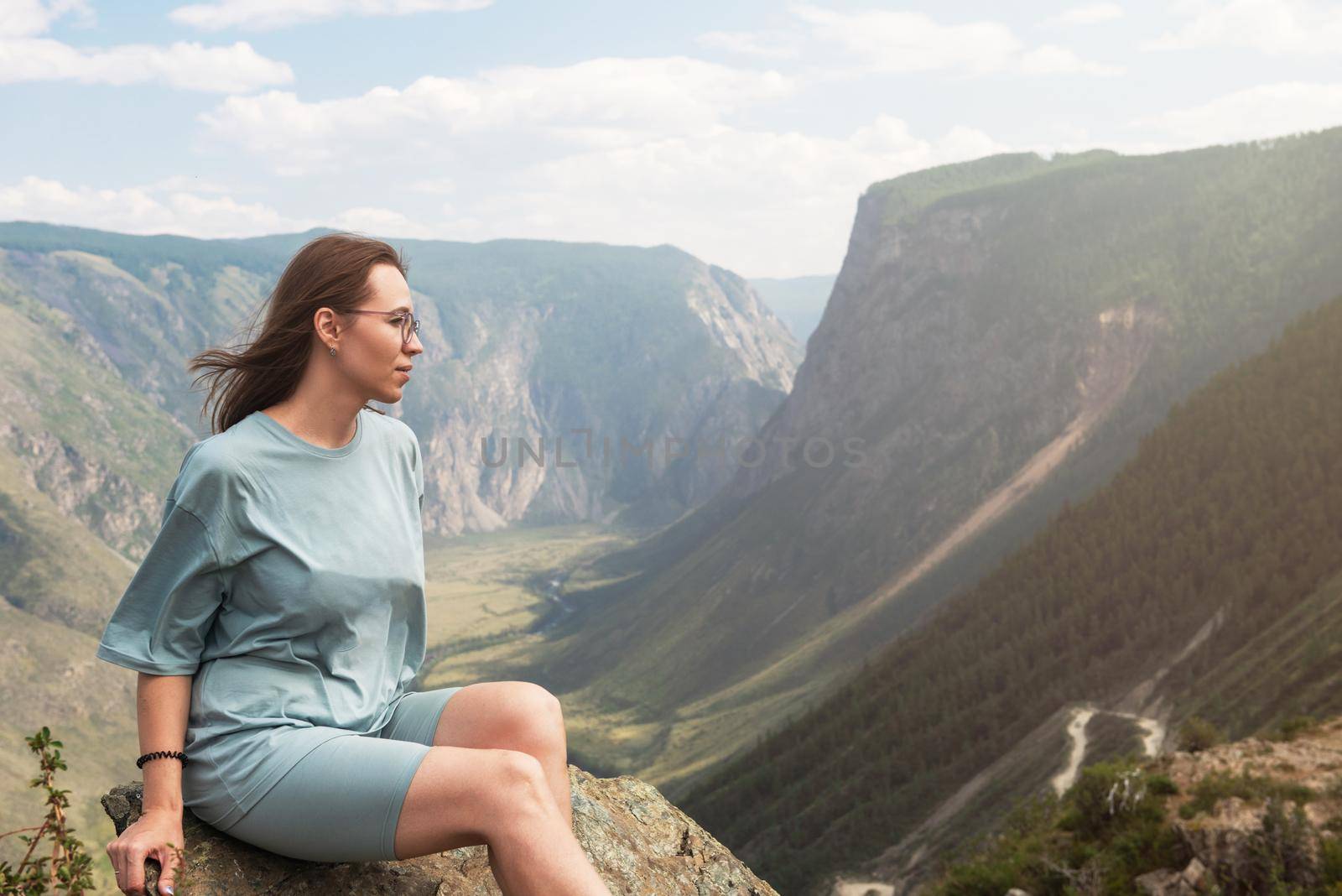 Woman on the top of Altai mountain, Katu Yaryk mountain pass and the valley of the river of Chulyshman, beauty summer day landcape. Travel, leisure and freedom concept