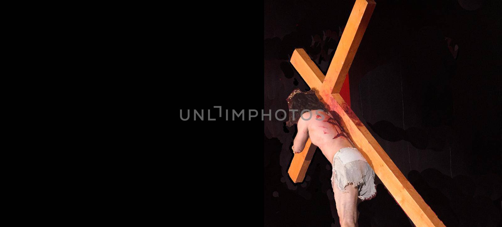 Jesus carrying the Cross into the darkness.Crucifixion of Jesus.Easter banner concept.