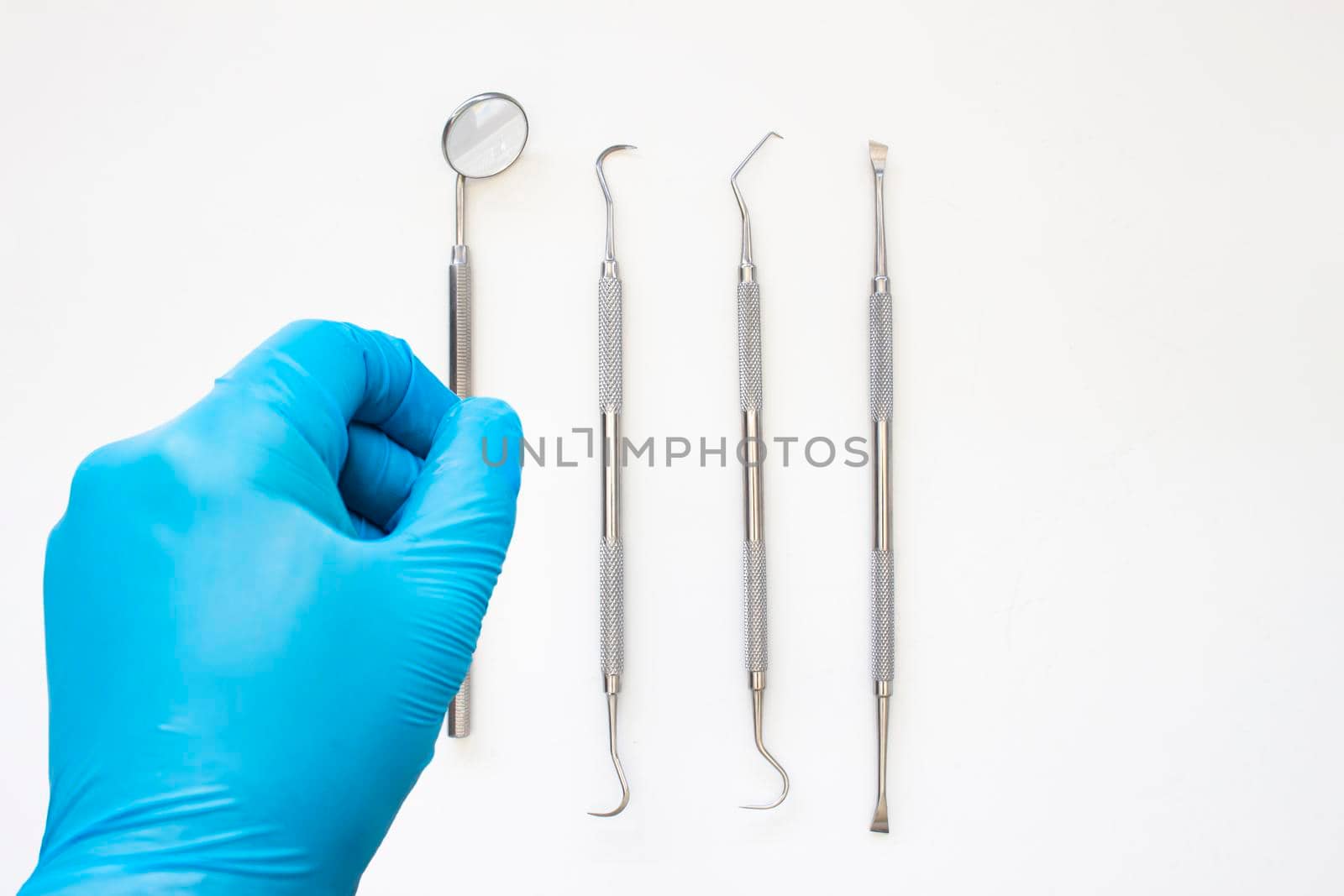 A dentist about to starts examining a patient. Professional Dental Hygiene cleaning tools. Calculus and Plaque Remover Set, Dental Scaler And Mouth Mirror Instruments Hygienist tools