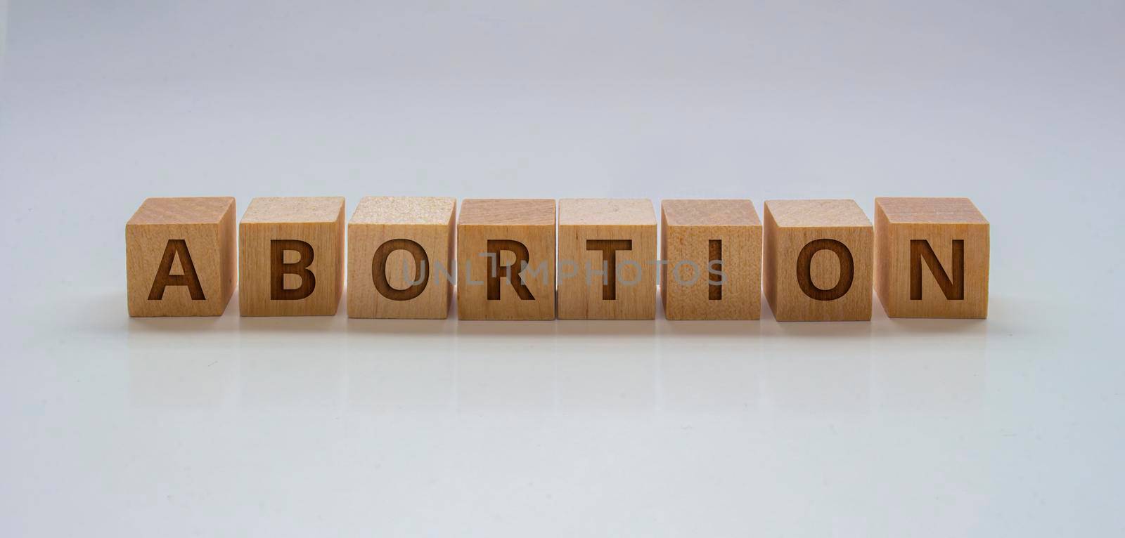 A Banner with wooden blocks with the text: "Abortion" on a clear background by oasisamuel