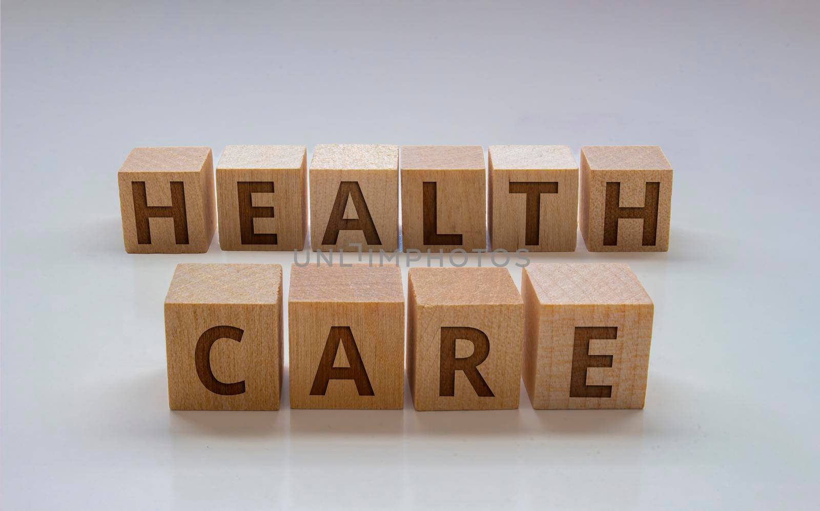 Wooden blocks with the text: "Health Care" on a clear background