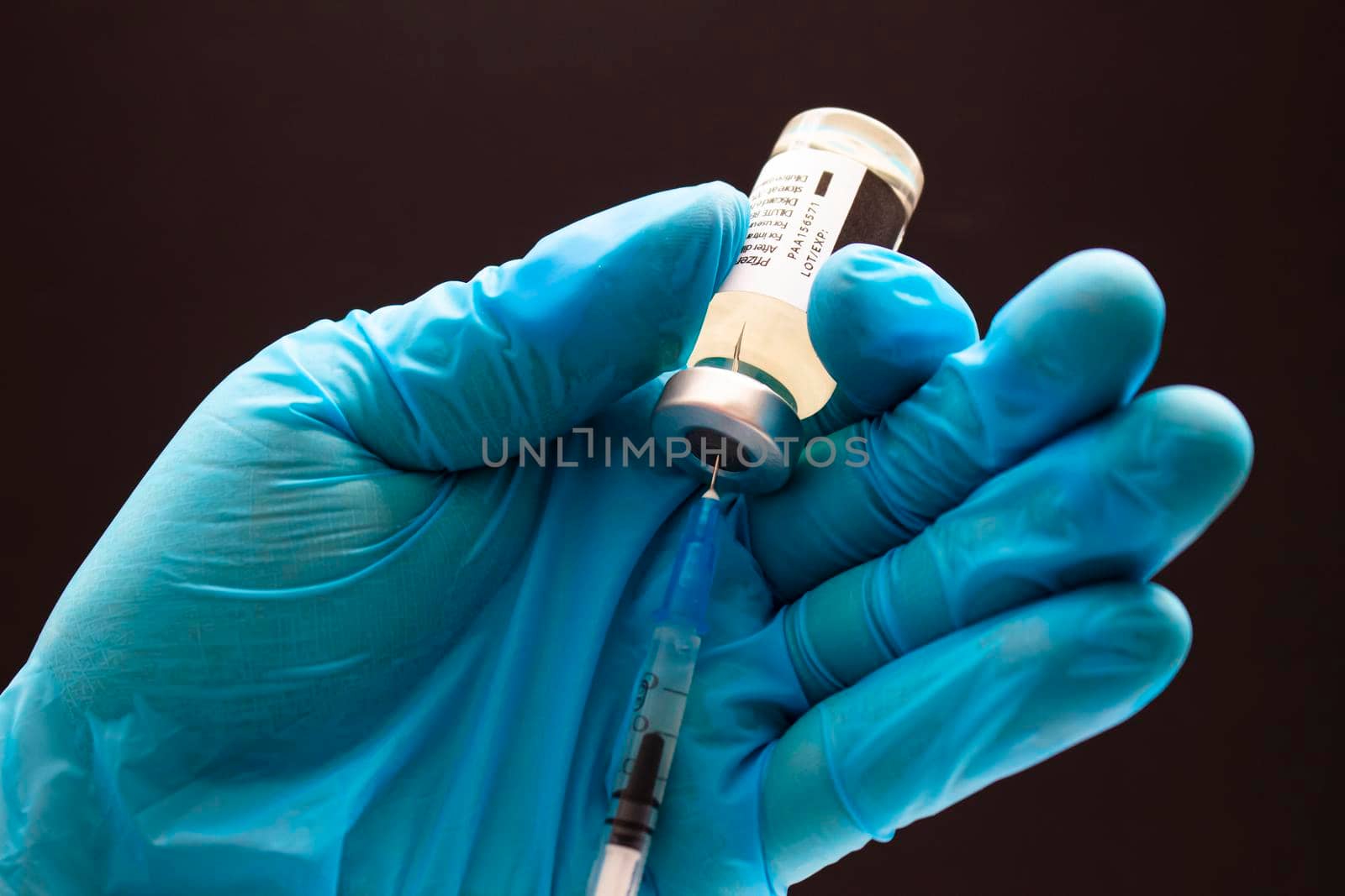 Calgary, Alberta. Canada. April 02, 2021. Health care worker with a Pfizer Vaccine and injection syringe. by oasisamuel