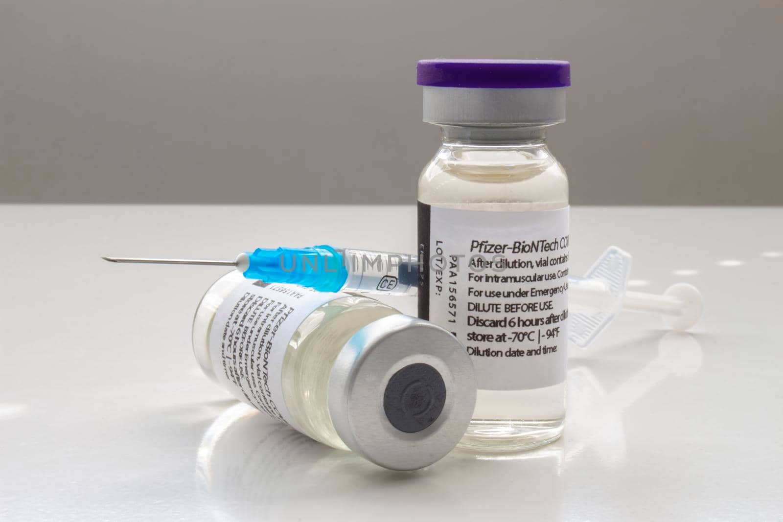 Calgary, Alberta. Canada. April 02, 2021. A couple of Pfizer Covid-19 vaccine vials with a syringe by oasisamuel