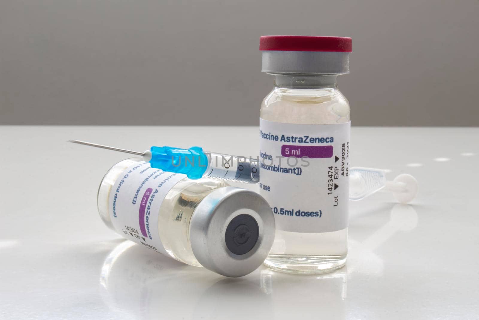 Calgary, Alberta. Canada. April 02, 2021. A couple of AstraZeneca Covid-19 vaccine vials with a syringe by oasisamuel