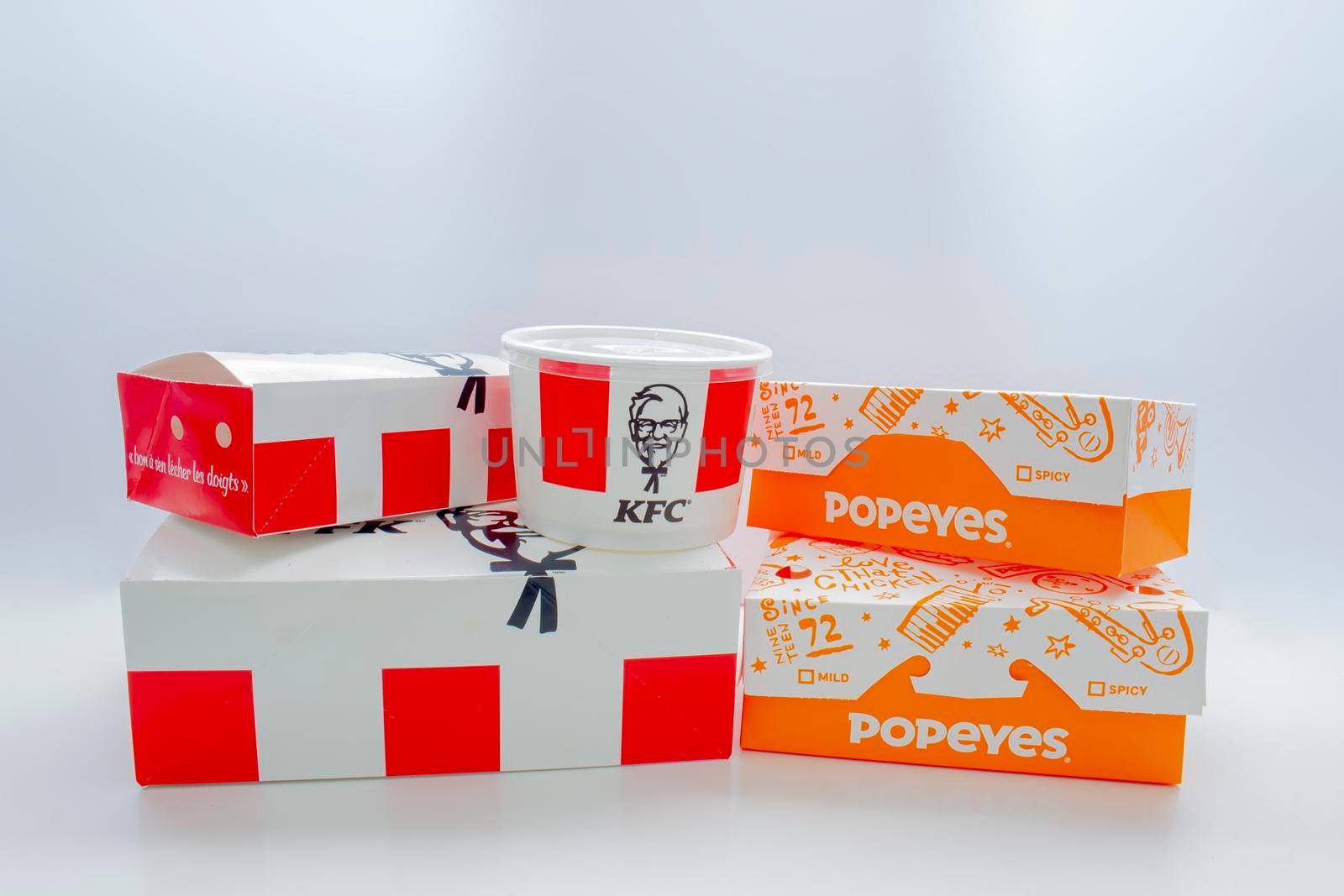 Calgary, Alberta, Canada. May 5, 2021. KFC and Popeyes Fast food boxes on a clear background. by oasisamuel