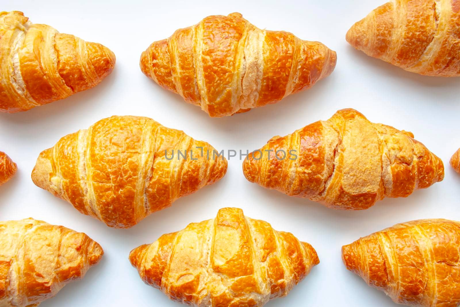 Croissants on a white background. Buttery, flaky, viennoiserie pastry of Austrian origin, but mostly associated with France.