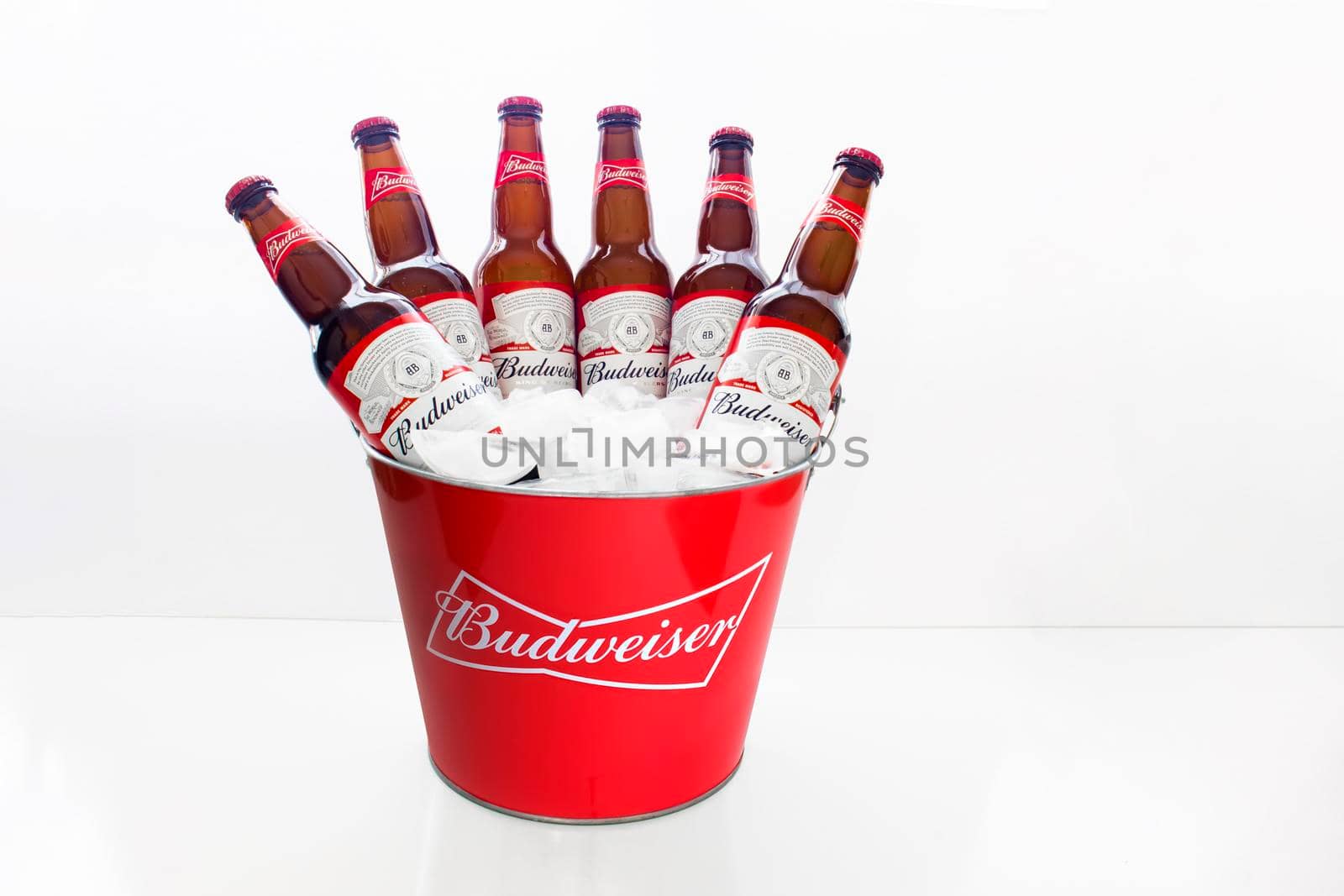 Calgary Alberta, Canada. April 02, 2021. A Budweiser Beer Bucket American-style pale lager with six beer bottles with ice on a white background.