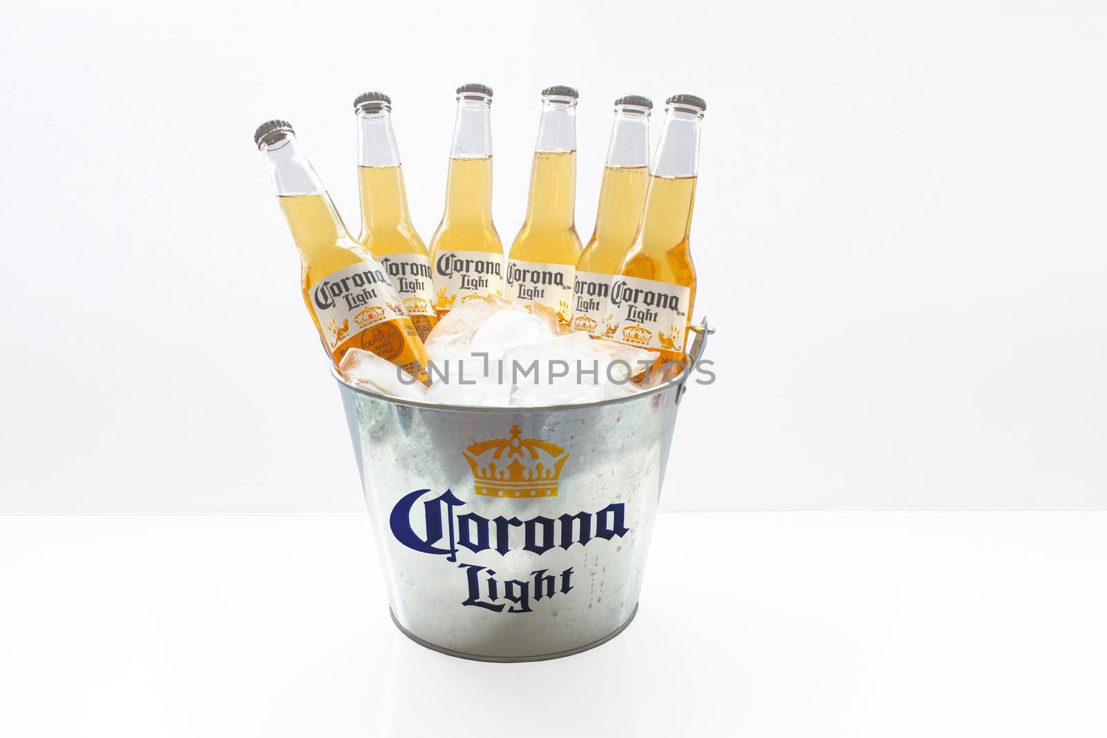 Calgary, Alberta, Canada. March 3, 2021. A beer bucket of Corona Light beers bottles with ice on a white background.