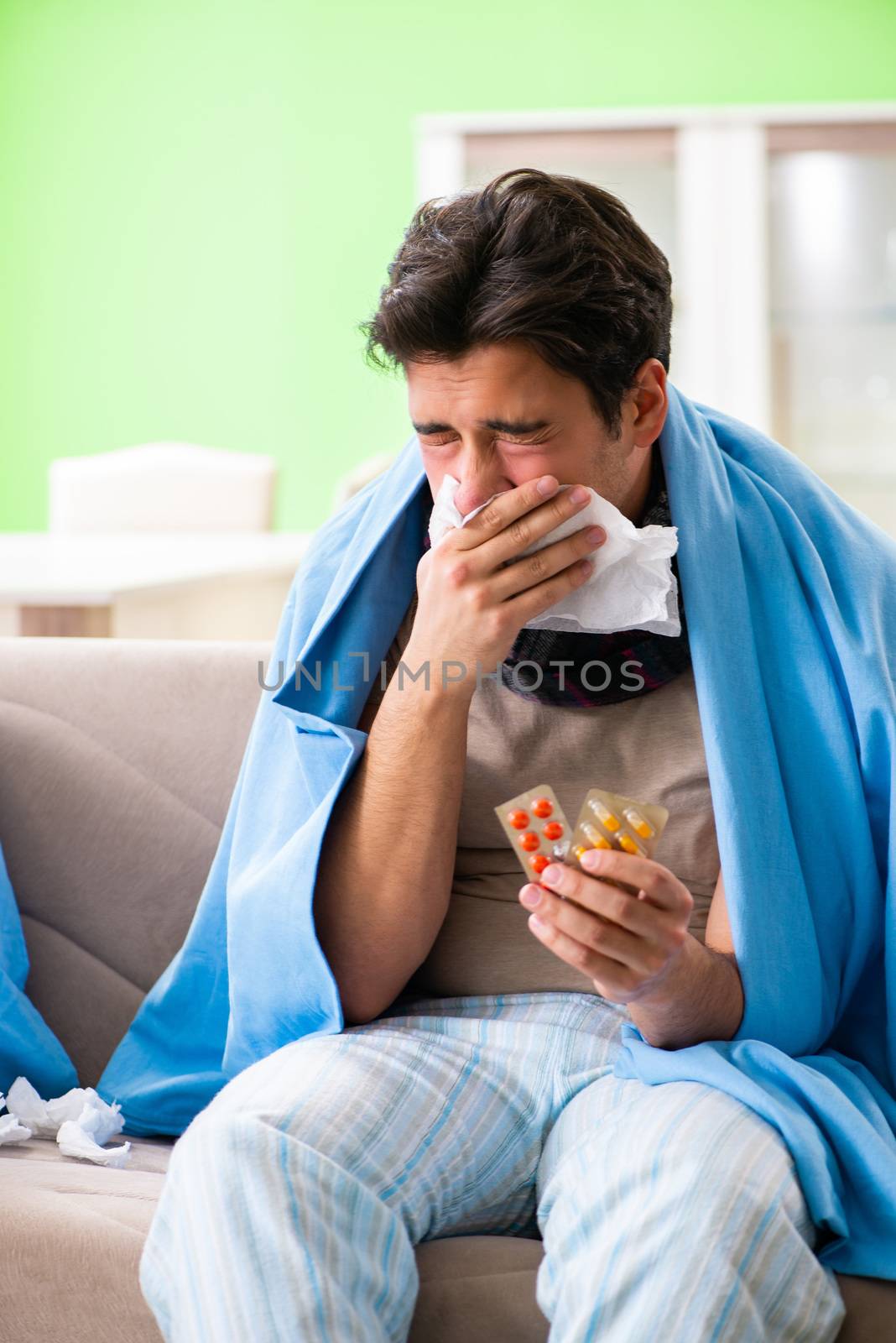 Sick young man suffering from flu at home